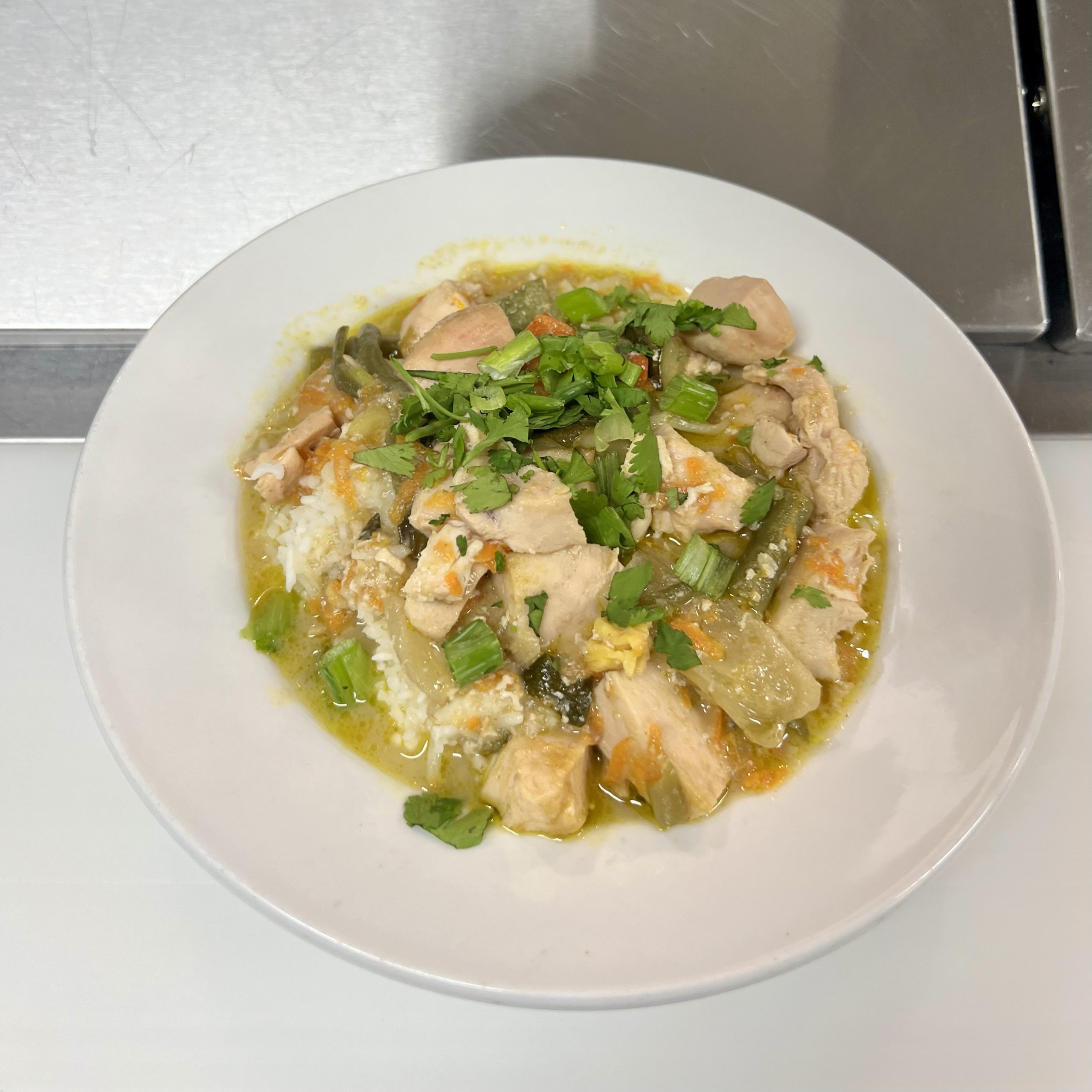 Thai Green Curry in a white bowl. 